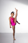 Photo of a 10 year old girl infront of a white background wearing a bright hot pink sheen leotard. The front features jelly yellow crystals, and the back has 4 thin straps twisted through a gathered back opening creating a traingle. 