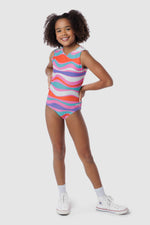 Photo of a 5 year old girl, standing iPhoto of a 10 year old girl standing infront of a white backdrop. Wearing a wavy pattern gymnastics leotard that is a mix of purple, aqua, white & purple. There are no crystals, making it great for training.