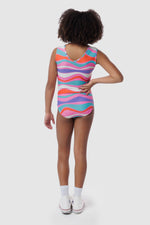 Photo of a 5 year old girl, standing iPhoto of a 10 year old girl standing infront of a white backdrop. Wearing a wavy pattern gymnastics leotard that is a mix of purple, aqua, white & purple. There are no crystals, making it great for training.